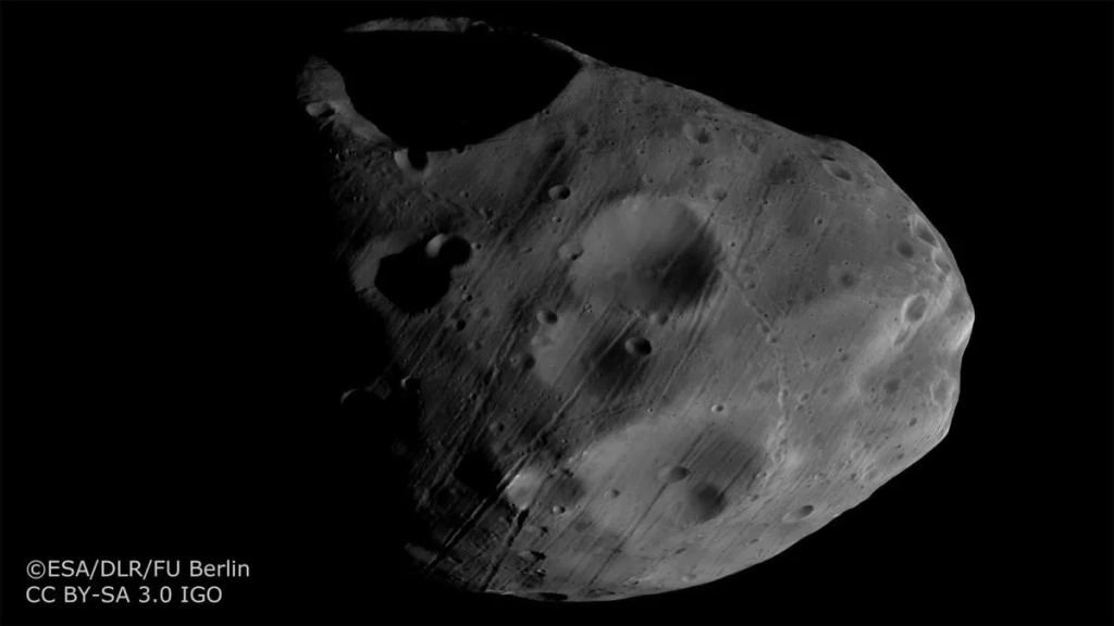 HRSC captured this image of Phobos in 2017. It shows Stickney Crater, Phobos' largest impact crater, and unusual grooves on the moon's surface.  Mars Express images helped scientists conclude that the grooves are likely from the impact ejecta.  Image credit: ESA/DLR/FU Berlin.  CC BY-SA 3.0 IGO