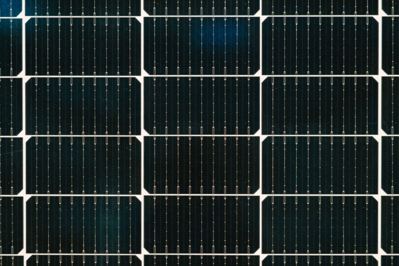 Image of a solar cell, showing dark black silicon and silver wiring.